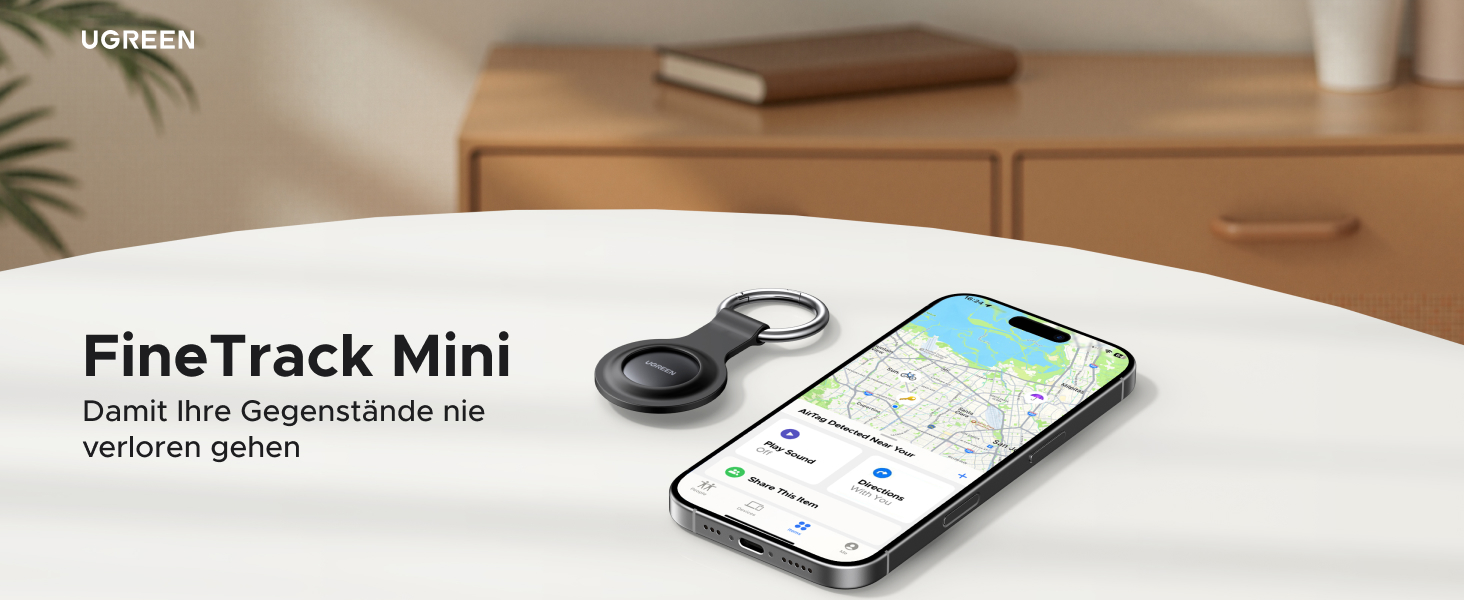 Der Text lautet „FineTrack Mini“. Produktaufnahme, die ein Smartphone mit auf dem Bildschirm angezeigter Tracking-Anwendungsoberfläche zeigt.