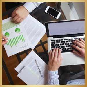 men working on laptops and data sheets