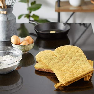 Bright yellow oven mits for cooking and baking in the kitchen