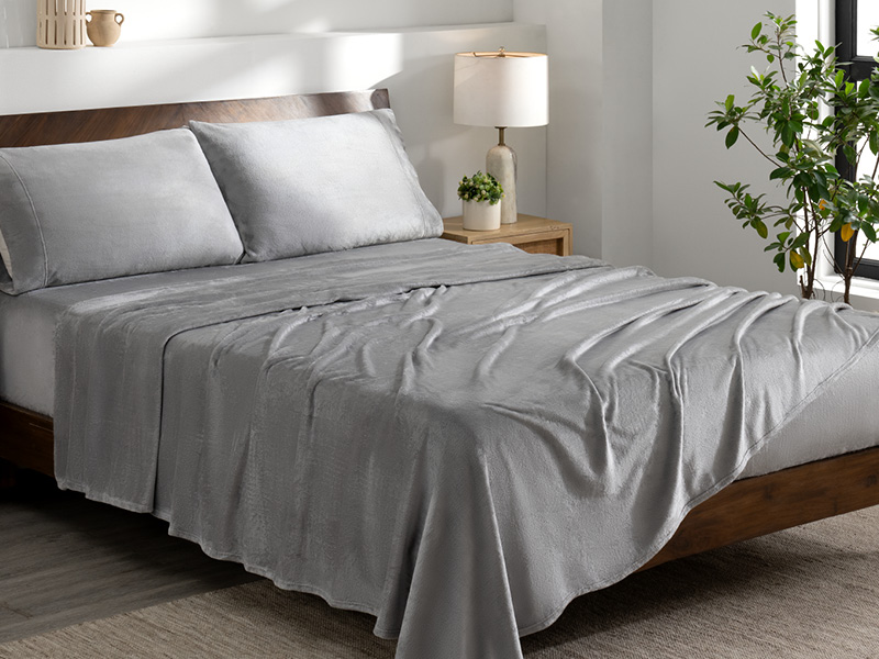 grey microplush sheet set, on a bed