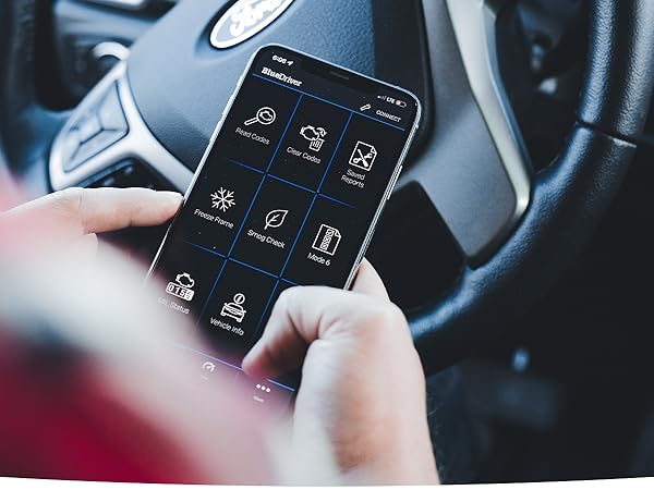 Man holding iphone and going through BlueDriver's iphone app while sitting in vehicle
