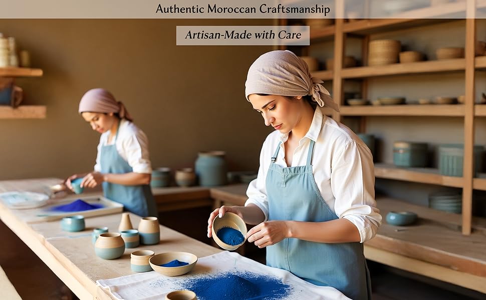 Artisan women in Moroccan workshop preparing vibrant Nila blue powder in clay bowls for skincare