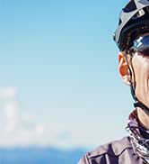 Action sports sequence showing figure jumping or performing aerial maneuvers against blue sky background.