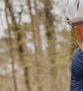Outdoor nature scene showing wooded area with fallen leaves and natural lighting.