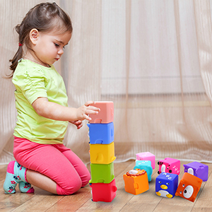 A girl is stacking the blocks