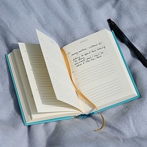 A photograph of The Gratitude Journal open on a table.