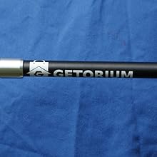 Folded trekking poles next to a backpack and carry bag for travel.