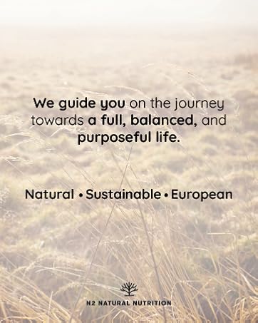 Text reads 'We guide you on the journey towards a full, balanced, and purposeful life. Natural • Sustainable • European'. Scenic background image of sunlit grass or wheat field.