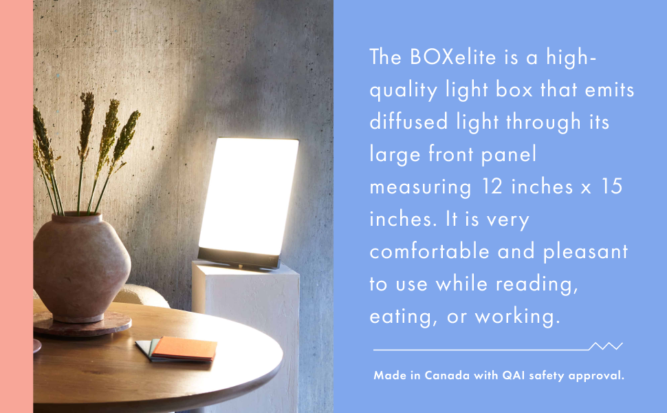 The BOXelite desk lamp on a pedestal lights up a vase. A concrete background with pastel colours.