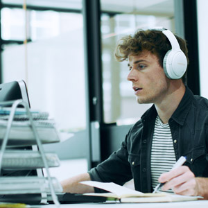 guy on a video call with client while wearing creative zen hybrid