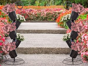 Image of two flower ot stands in walkway, with pink and white flowers potted inside.