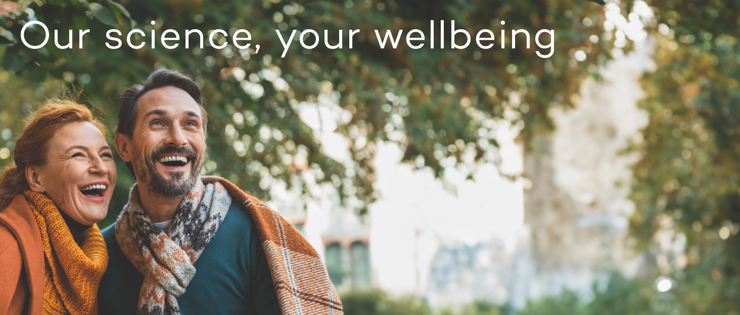 Outdoor scene with trees. Text overlay reads 'Our science, your wellbeing'. Sunny day with natural lighting.