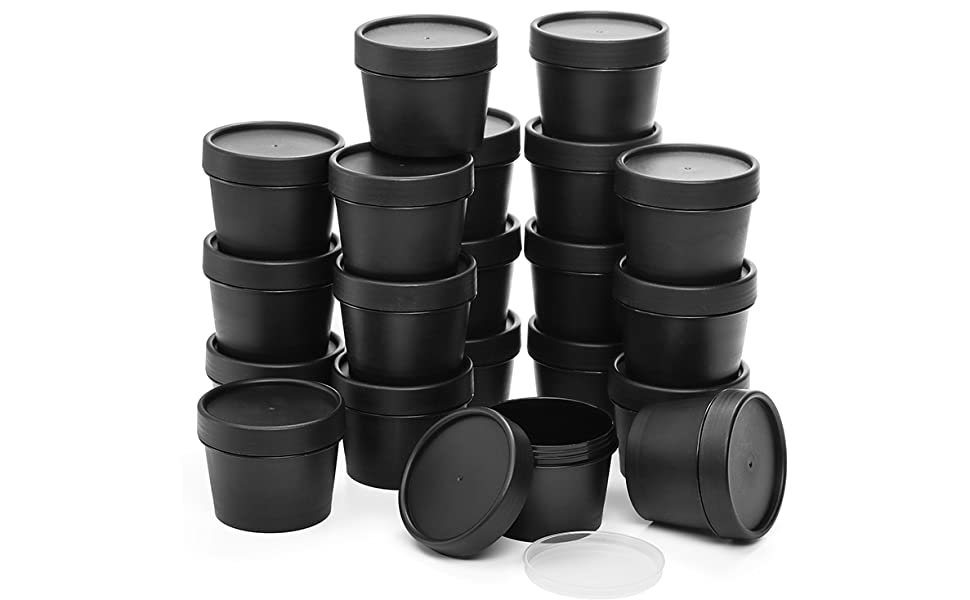 Collection of black plastic containers with lids, stacked in various arrangements. Uniform size and shape, suitable for storage or packaging.