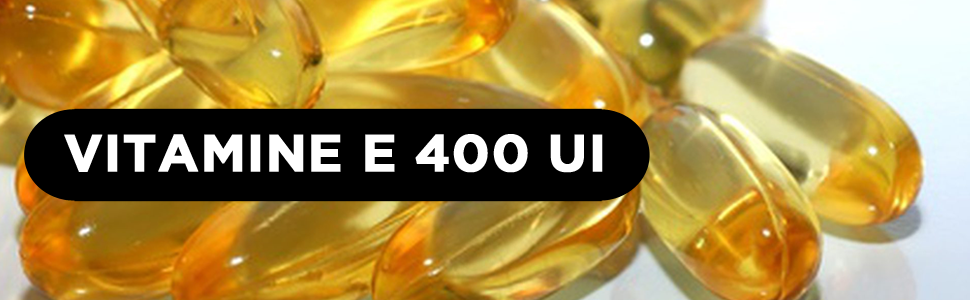 Le texte indique « VITAMINE E 400 UI ». Plusieurs gélules ou suppléments de couleur dorée montrés en très gros plan sur un fond chaud.