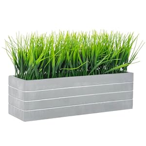 faux grass plant potted in cement planter
