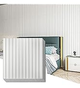Modern radiator or heating panel mounted on wall with vertical ribbed design in light gray or white finish, showing multiple connected sections.