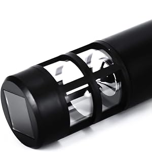 black Solar powered light laid down, for garden has bottom spike and solar panel on top of product