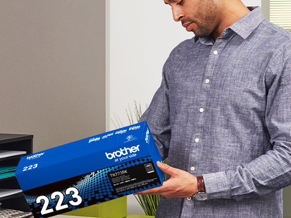 Man Carrying TN223BK Box