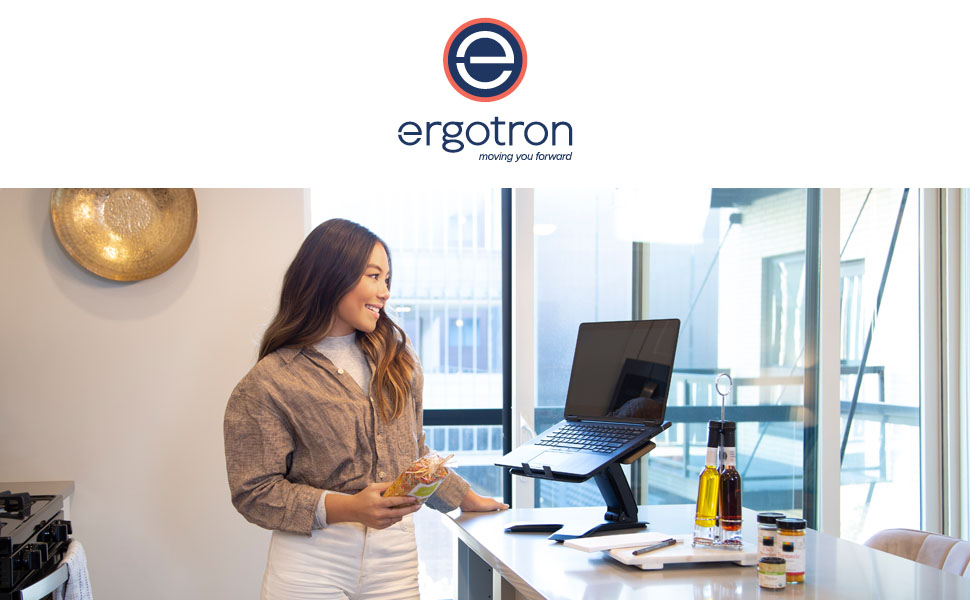 Woman using Neo-Flext Laptop Stand in the kitchen while preparing a recipe.