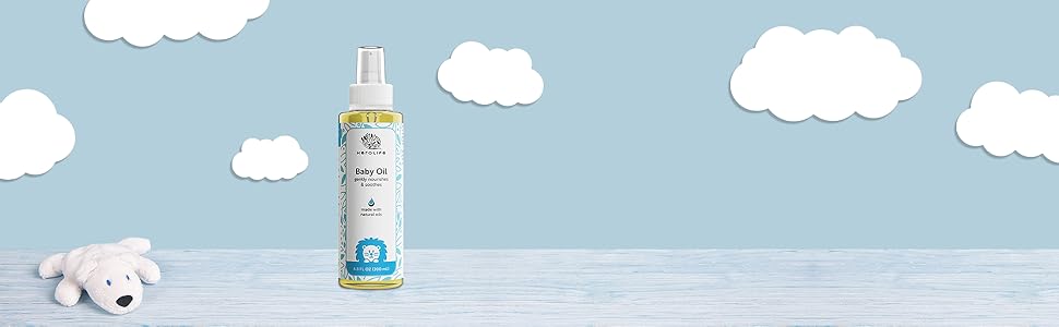 Herolife Baby Oil on a baby's dresser with stuffed toy bear and clouds