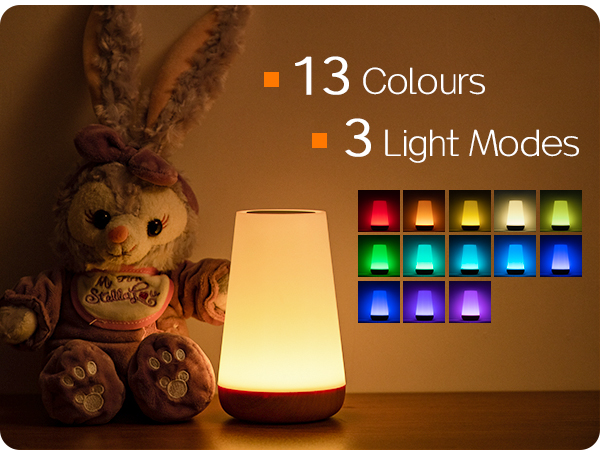 Illuminated lamp with 13 color options and 3 light modes. A stuffed animal sits next to it, creating a cozy atmosphere.