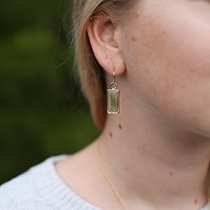 Women wearing fern leaf earrings