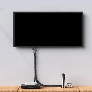 a tv mounted to a wall with a remote control.
