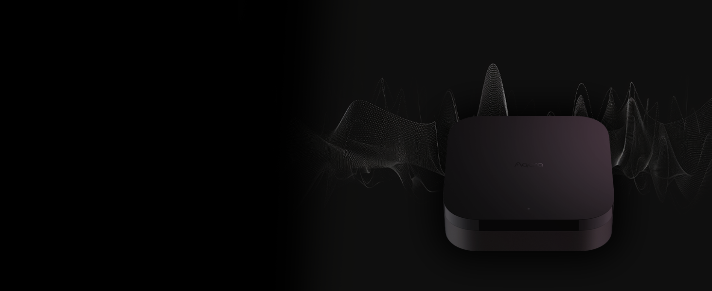 A small, dark rectangular device with rounded corners, possibly a streaming or network device, set against a black background.