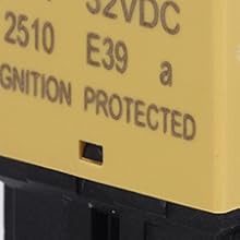 Close-up of a yellow electronic component labeled '2510 E39' and 'IGNITION PROTECTED'. The device appears to be a circuit breaker or switch with visible text and a black base.