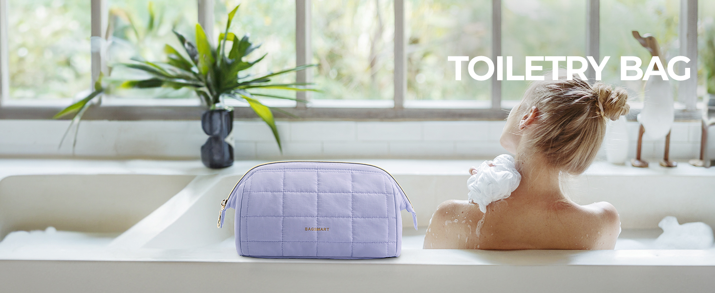 Lavender quilted toiletry bag on bathtub edge. Rectangular shape with zipper closure. Person visible bathing. Text 'TOILETRY BAG' overlaid on image.