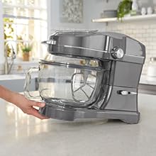 Closeup of a hand tilting and pulling the Kenmore Elite Ovation stand mixer across a kitchen counter