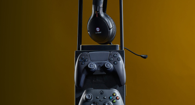 Gaming accessories: Black wireless headphones, black gaming controller, and a blue controller stacked vertically against a yellow background.