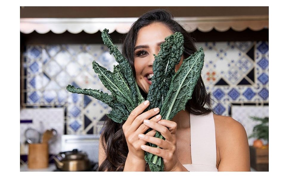 Kimberly Snyder holding kale in her kitchen