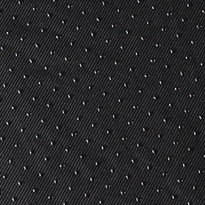 Close-up of black textured fabric or material with a repeating pattern of small raised dots or perforations.