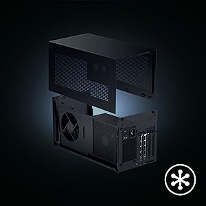 Vista ampliada de un componente de ordenador o consola de videojuegos de color negro sobre un fondo oscuro, que muestra la estructura interna del hardware con ventiladores y puertos. Símbolo de asterisco visible en la parte inferior derecha.