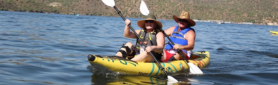 A man and woman paddling the Buoy Watersports Tandem Tahoe Kayak on a lake