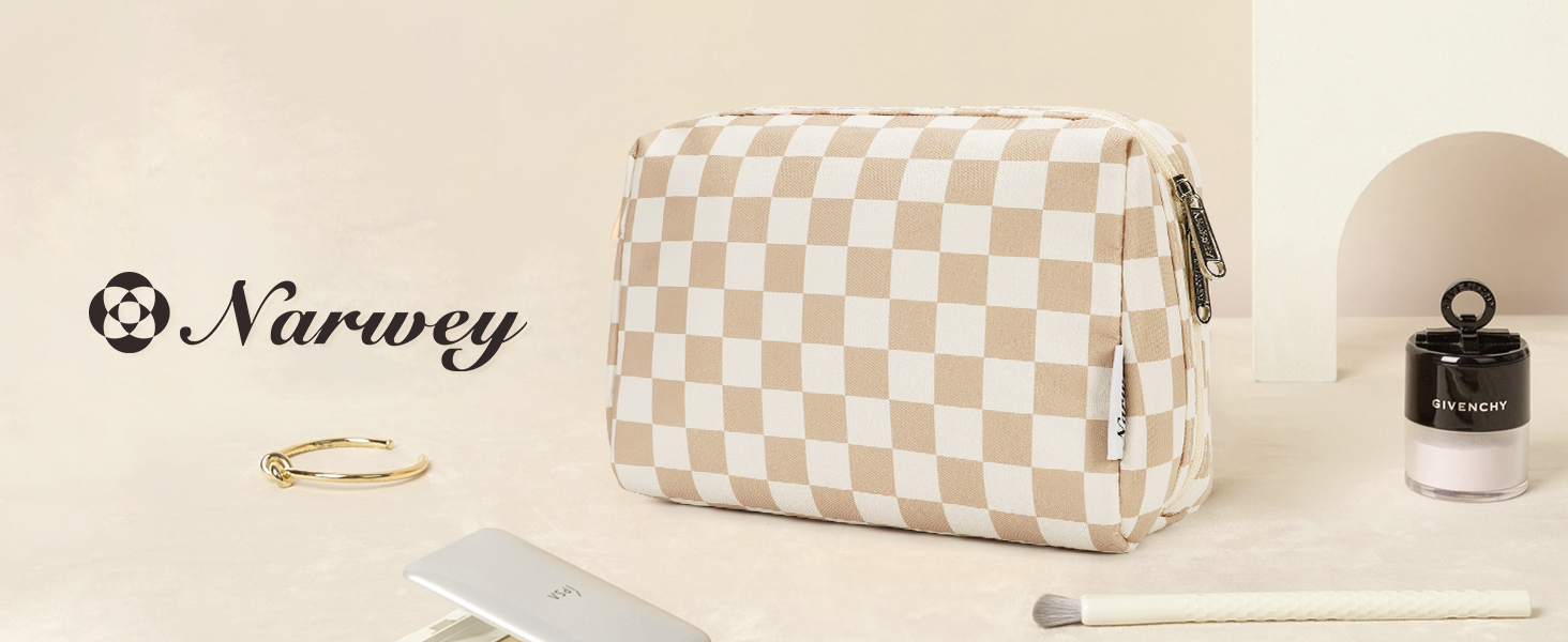 Small cream and white checkered makeup or cosmetic bag with zip closure, displayed on beige surface alongside minimal accessories.