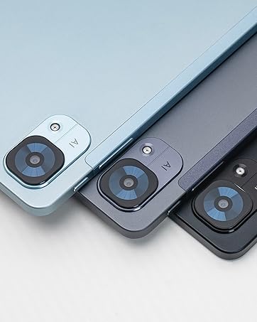 Three tablet or device backs in light blue, silver, and black colors, showcasing dual camera modules in the corner of each device.