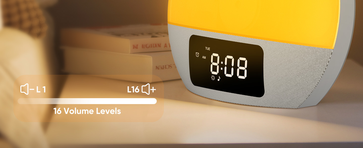 Digital alarm clock with a rounded rectangular shape. Display shows time as 8:08. Device has multiple buttons and appears to have volume control functionality.