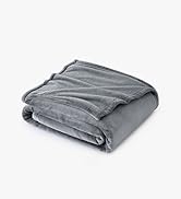 Folded gray blanket or throw with ribbed texture pattern, photographed against white background.
