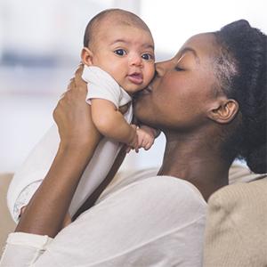 Mom kissing baby's cheek