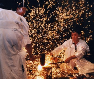 a man is using a hammer to cut a piece of wood.