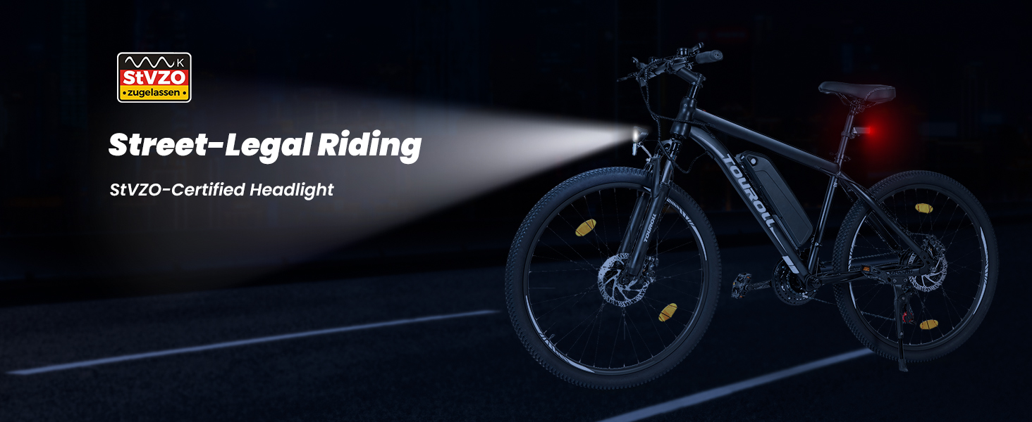 Black bicycle with StVZO-certified headlight shown in low-light conditions, demonstrating street-legal riding capabilities.