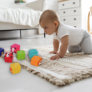 A baby is attracted by bright blocks and crawling forward