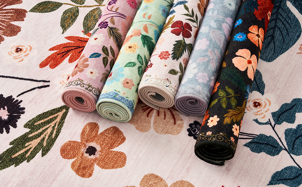 Family photo of washable floral rugs in 5 colors