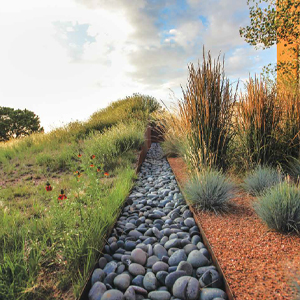 image of a rock aqueduct in the desert from beyond the garden