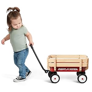 Girl pulling miniature steel and wood wagon by the working handle