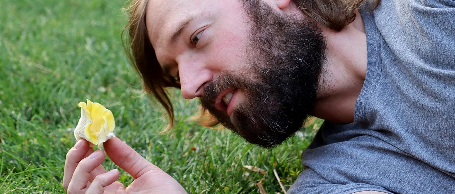 Gorgeous man holding a mushroom