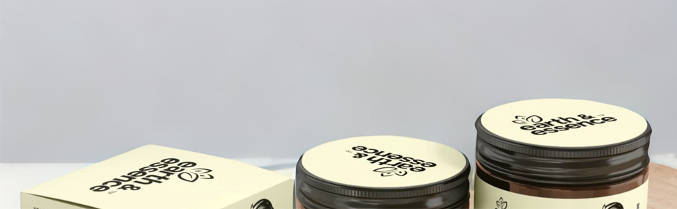 Three round, shallow jars with dark lids, labeled 'Blossom Butter'. Jars appear to contain a cream or butter-like substance.