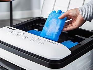 Close-up of person inserting blue cleaning cartridge into white printer or scanner device, control panel visible.